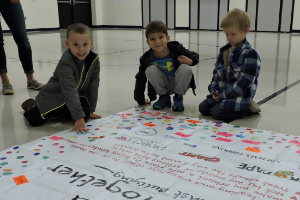 Students Placing Tape on Sign
